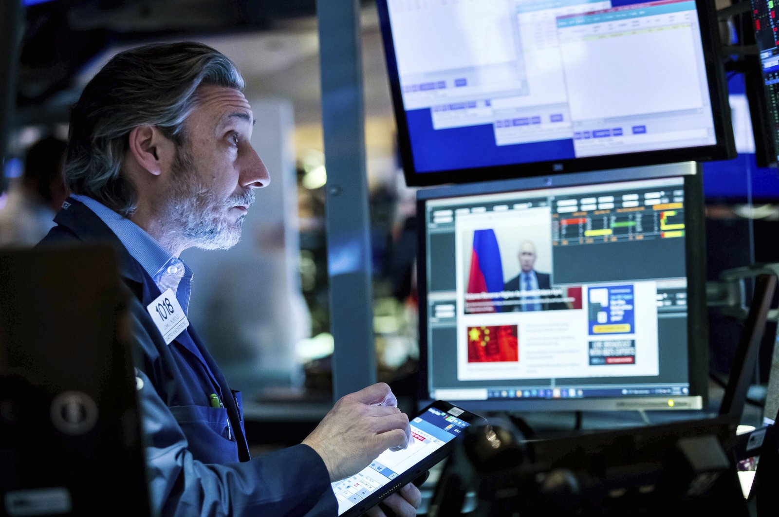 In this photo provided by the New York Stock Exchange, trader John Romolo works on the floor, New Your, U.S., Friday, Feb. 25, 2022. (Courtney Crow/New York Stock Exchange via AP)