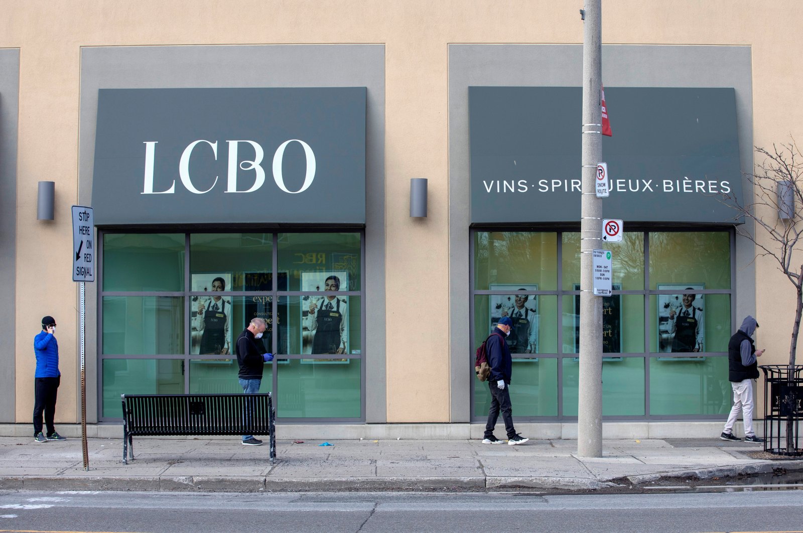 People wait outside of the LCBO (Liquor Control Board of Ontario) to purchase alcohol in Toronto, Ontario, Canada April 9, 2020. (Reuters File Photo)