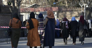 Afghan students walk on a street before they enter their university in Kabul, Afghanistan, Feb. 26, 2022. (AP Photo)