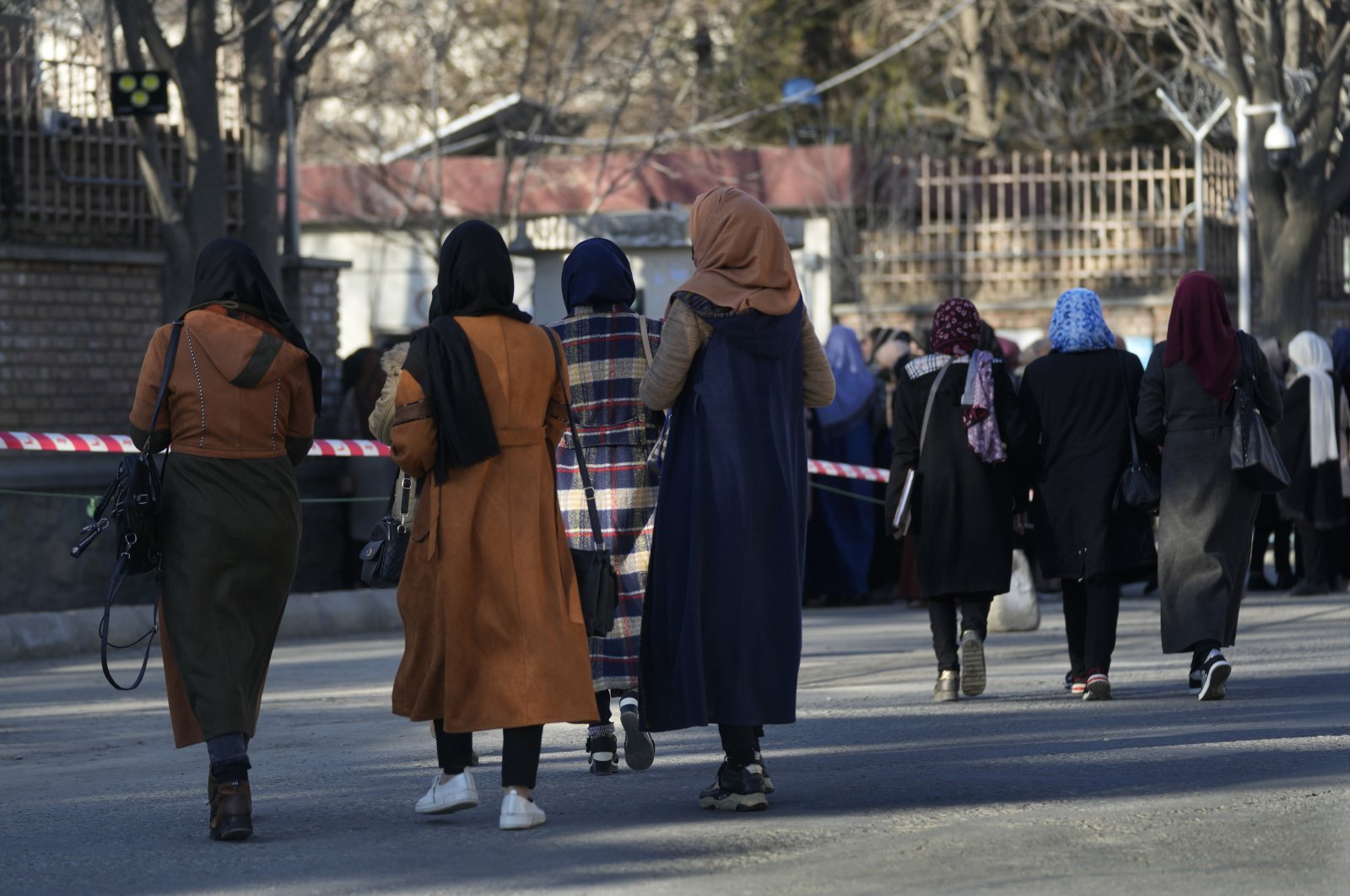 Afghan students walk on a street before they enter their university in Kabul, Afghanistan, Feb. 26, 2022. (AP Photo)