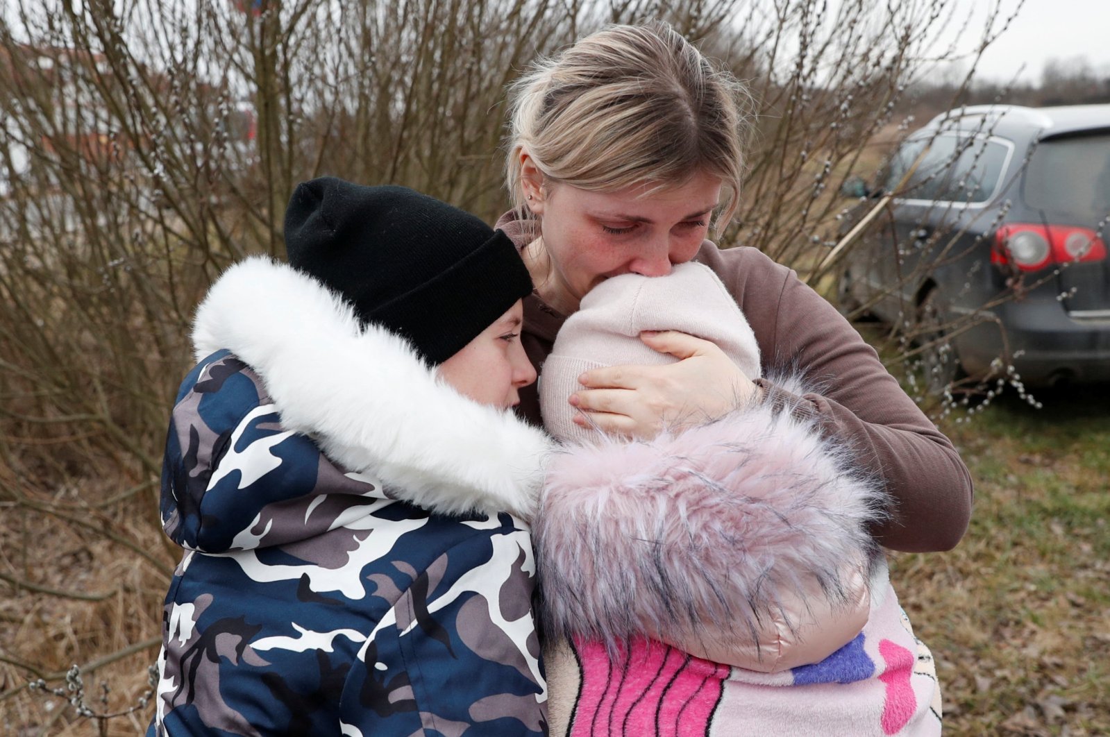 Anna Semyuk, hugs her children at the border, Hungary, Feb. 26, 2022. (Reuters Photo)