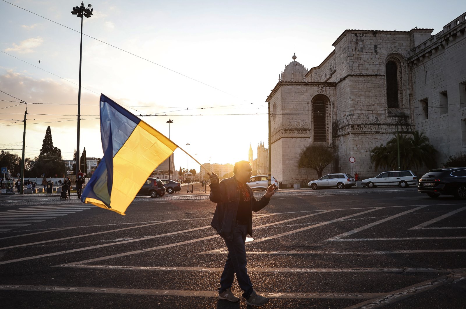 A man holds a Ukraine flag as he takes part in the Human Cordon for Peace in Ukraine, in Lisbon, Portugal, Feb. 26, 2022. (EPA Photo)