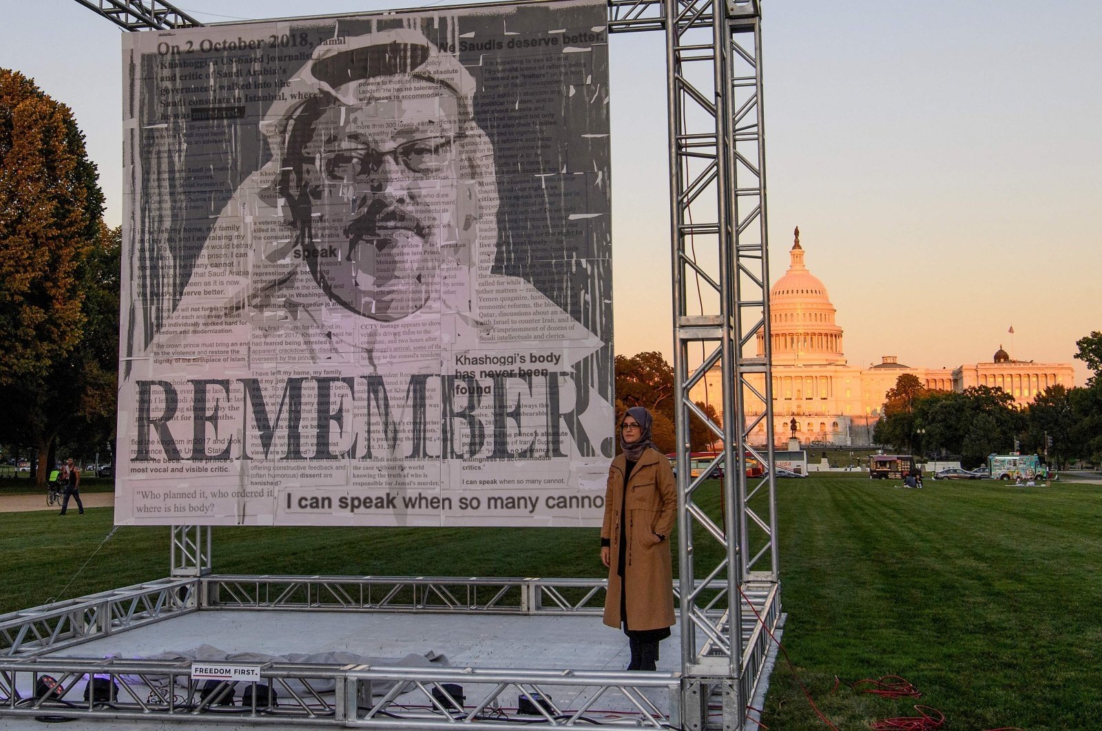 Hatice Cengiz (R), fiancee of Saudi journalist and dissident Jamal Khashoggi, poses next to a portrait of Khashoggi on the National Mall in Washington, D.C., U.S., Oct. 1, 2021. (AFP Photo)