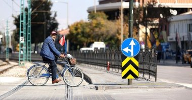 A man rides a bicycle across a tramline in Konya, central Turkey, Oct. 22, 2021. (AA Photo)