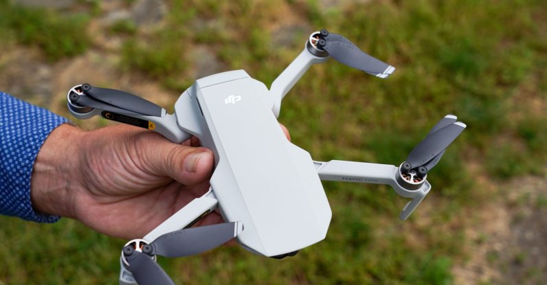 Ralph Werner of Quadrocopter Flight School holds a drone, a DJI Mavic Mini, in a park. (Reuters File Photo)