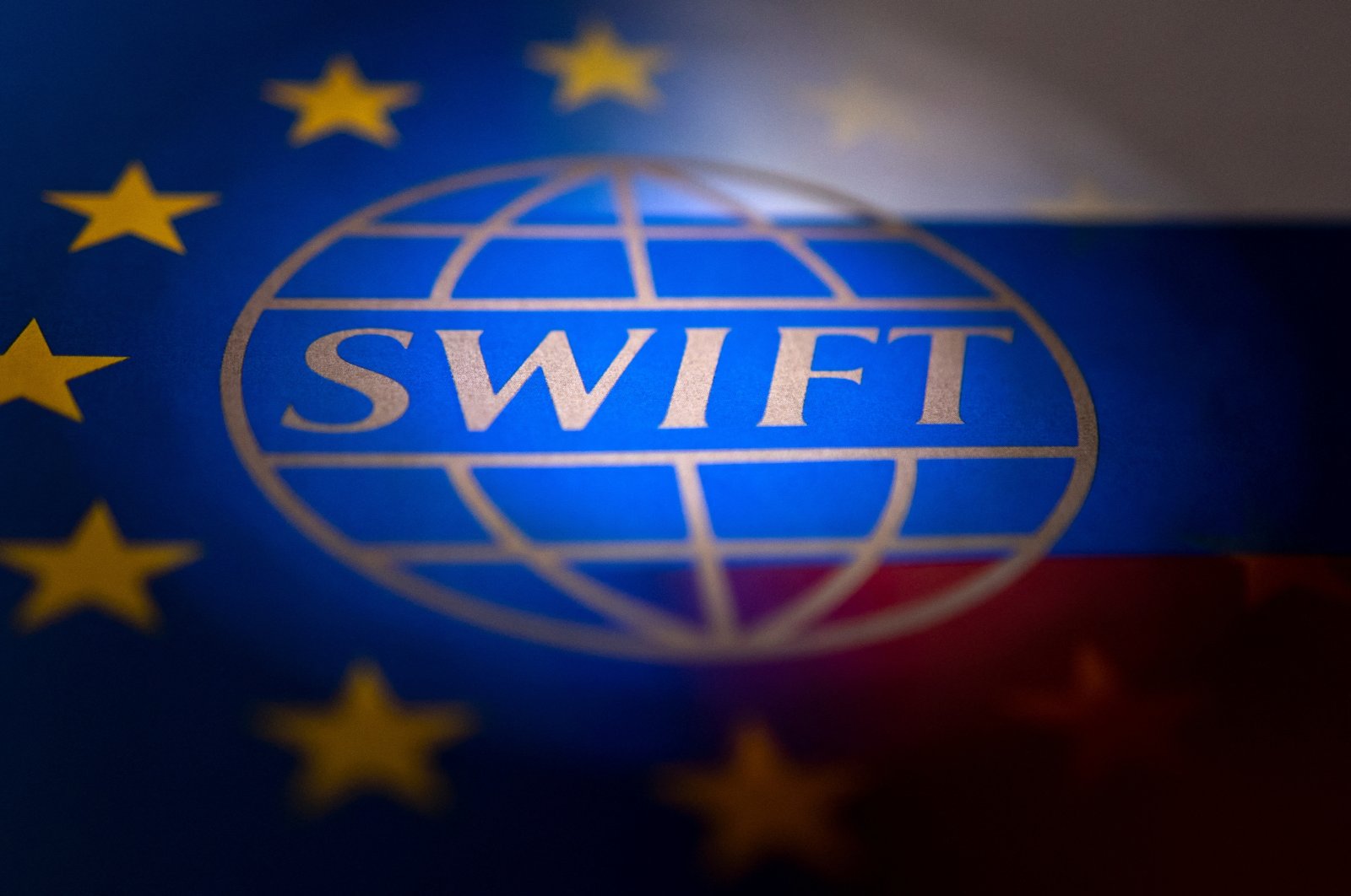 The SWIFT logo is pictured with EU and Russian flags in this illustration picture taken Feb. 26, 2022. (Reuters Photo)