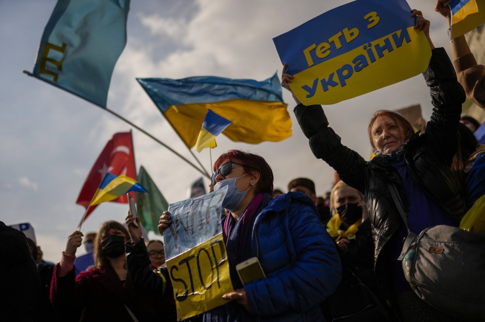 Pro-Ukrainian demonstrators hold banners and Ukrainian flags as they shout slogans during a protest in Istanbul, Turkey, Saturday, Feb. 26, 2022. (AP Photo)