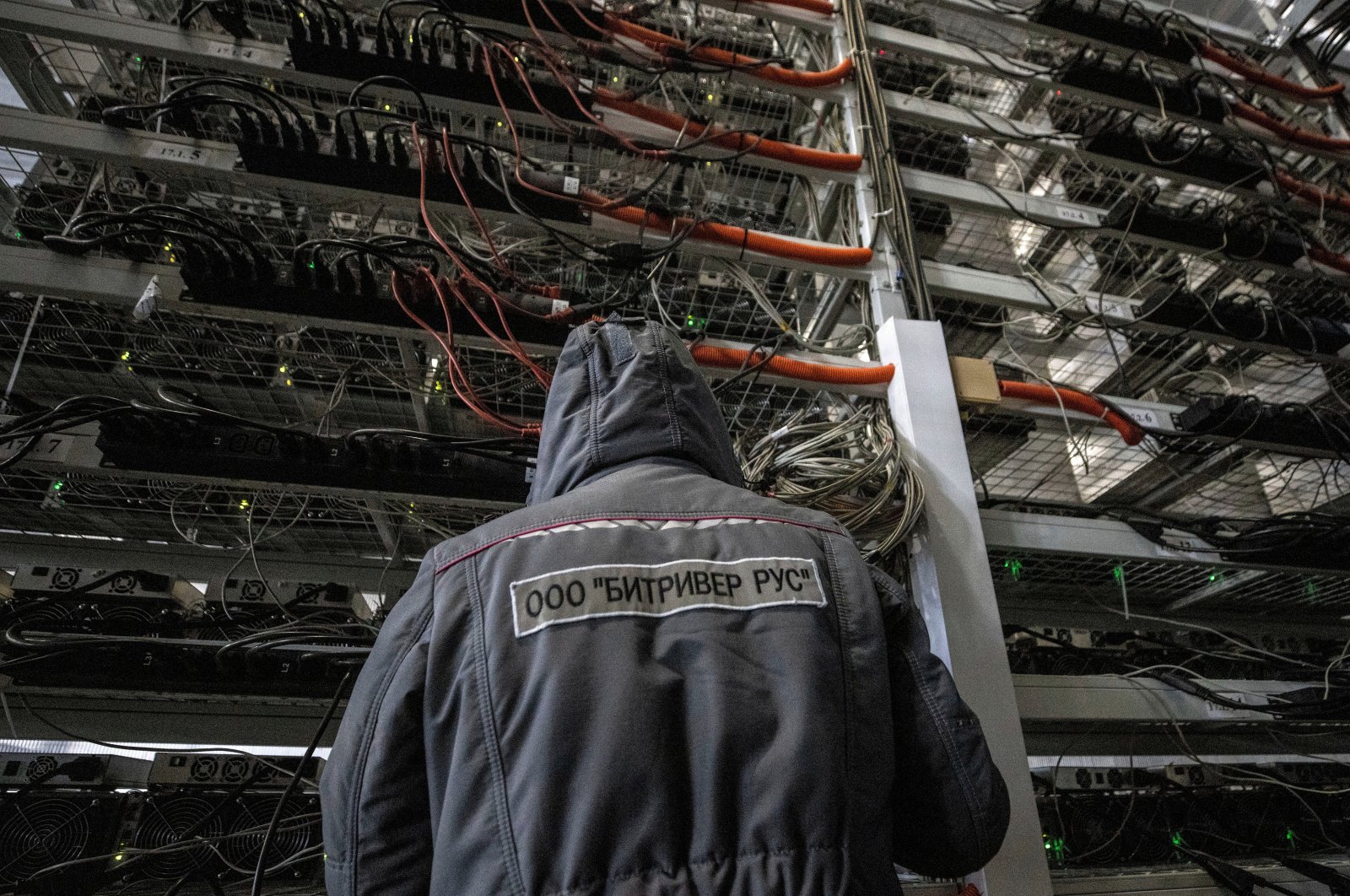An employee works at the data centre of BitRiver company providing services for cryptocurrency mining in the city of Bratsk in Irkutsk Region, Russia, March 2, 2021. (Reuters Photo)