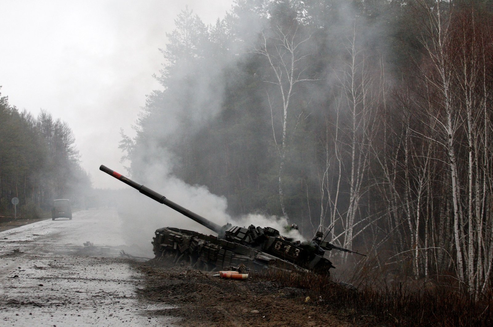 Smoke rises from a Russian tank destroyed by Ukrainian forces on the side of a road in the Luhansk region, Ukraine, Feb. 26, 2022. (AFP Photo)