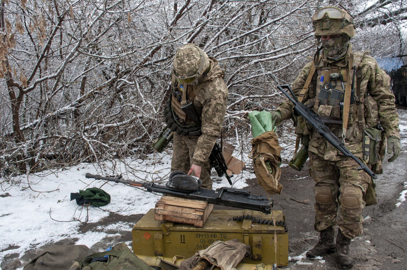 Ukrainian soldiers handle equipment outside Kharkiv, Ukraine, Feb. 26, 2022. (AP Photo)