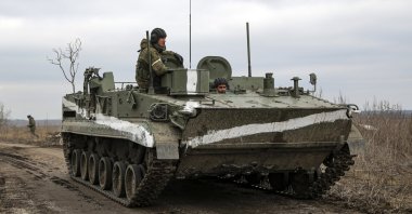 An armored vehicle rolls outside Mykolaivka, Donetsk region, the territory controlled by pro-Russian militants, eastern Ukraine, Feb. 27, 2022. (AP Photo)