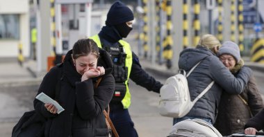 Family members hug as they reunite, after fleeing the conflict in Ukraine, at the Medyka border crossing, in Poland, Feb. 27, 2022. (AP Photo)