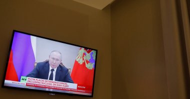 Russian President Vladimir Putin is seen on a TV screen in a hotel during a live news broadcast of the Russia Today (RT) channel TV, after Russia launched a massive military operation against Ukraine, Madrid, Spain, Feb. 27, 2022. (Reuters Photo)