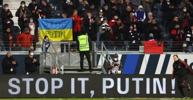 Football fans hold an anti-war banner in support of Ukraine during a Bundesliga match between Eintracht Frankfurt and Bayern Munich, Frankfurt, Germany, Feb. 26, 2022. (Reuters Photo)