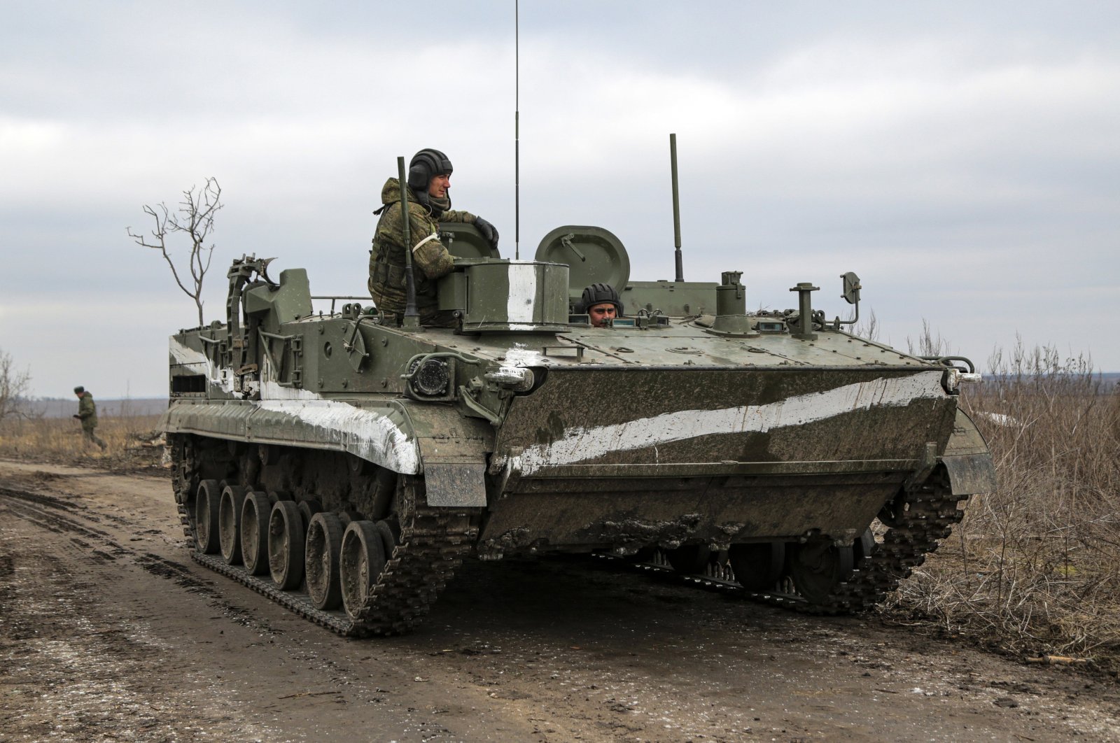 An armored vehicle rolls outside Mykolaivka, Donetsk region, the territory controlled by pro-Russian militants, eastern Ukraine, Feb. 27, 2022. (AP Photo)