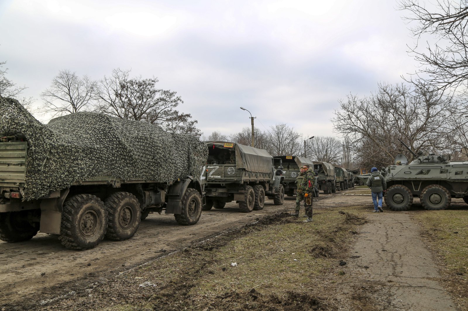 A convoy of military trucks parks in a street in Mykolaivka, in the Donetsk region, a territory controlled by pro-Russian militants, eastern Ukraine, Feb. 27, 2022. (AP Photo)