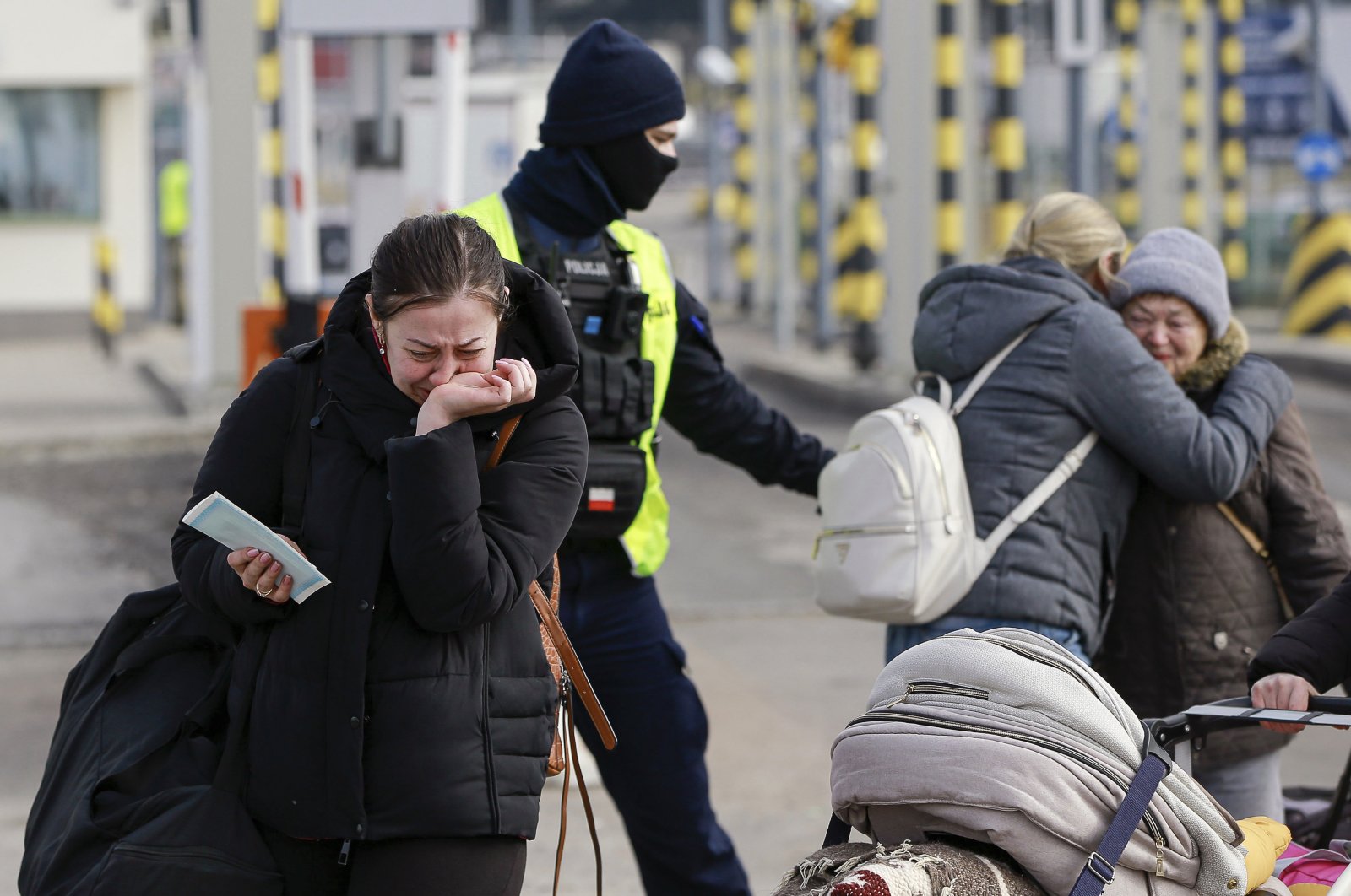 Family members hug as they reunite, after fleeing the conflict in Ukraine, at the Medyka border crossing, in Poland, Feb. 27, 2022. (AP Photo)