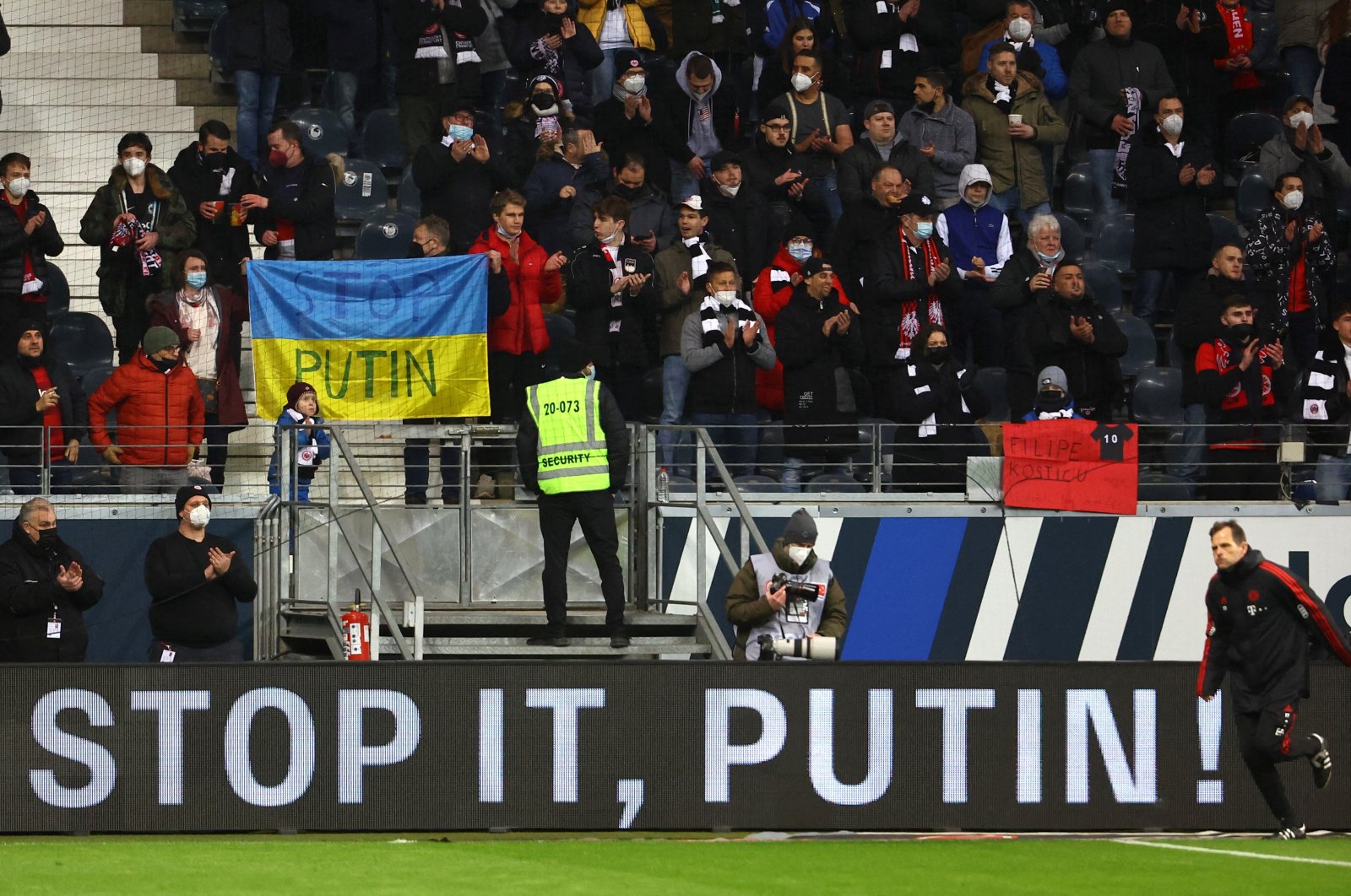 Football fans hold an anti-war banner in support of Ukraine during a Bundesliga match between Eintracht Frankfurt and Bayern Munich, Frankfurt, Germany, Feb. 26, 2022. (Reuters Photo)