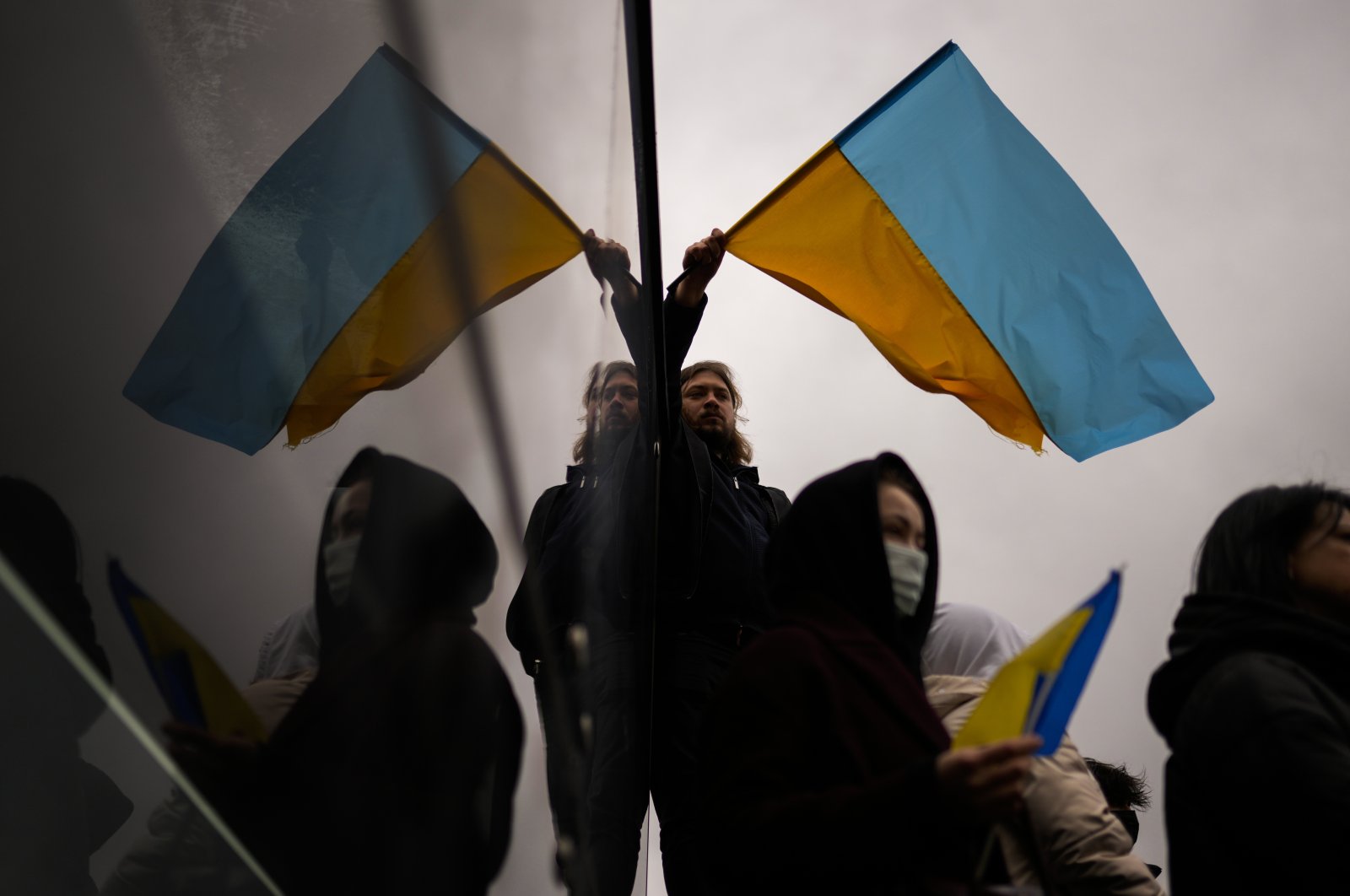 Pro-Ukrainian people wave Ukrainian flags during a protest against Russia's invasion of Ukraine in Istanbul, Turkey, Feb. 28, 2022. (AP File Photo)