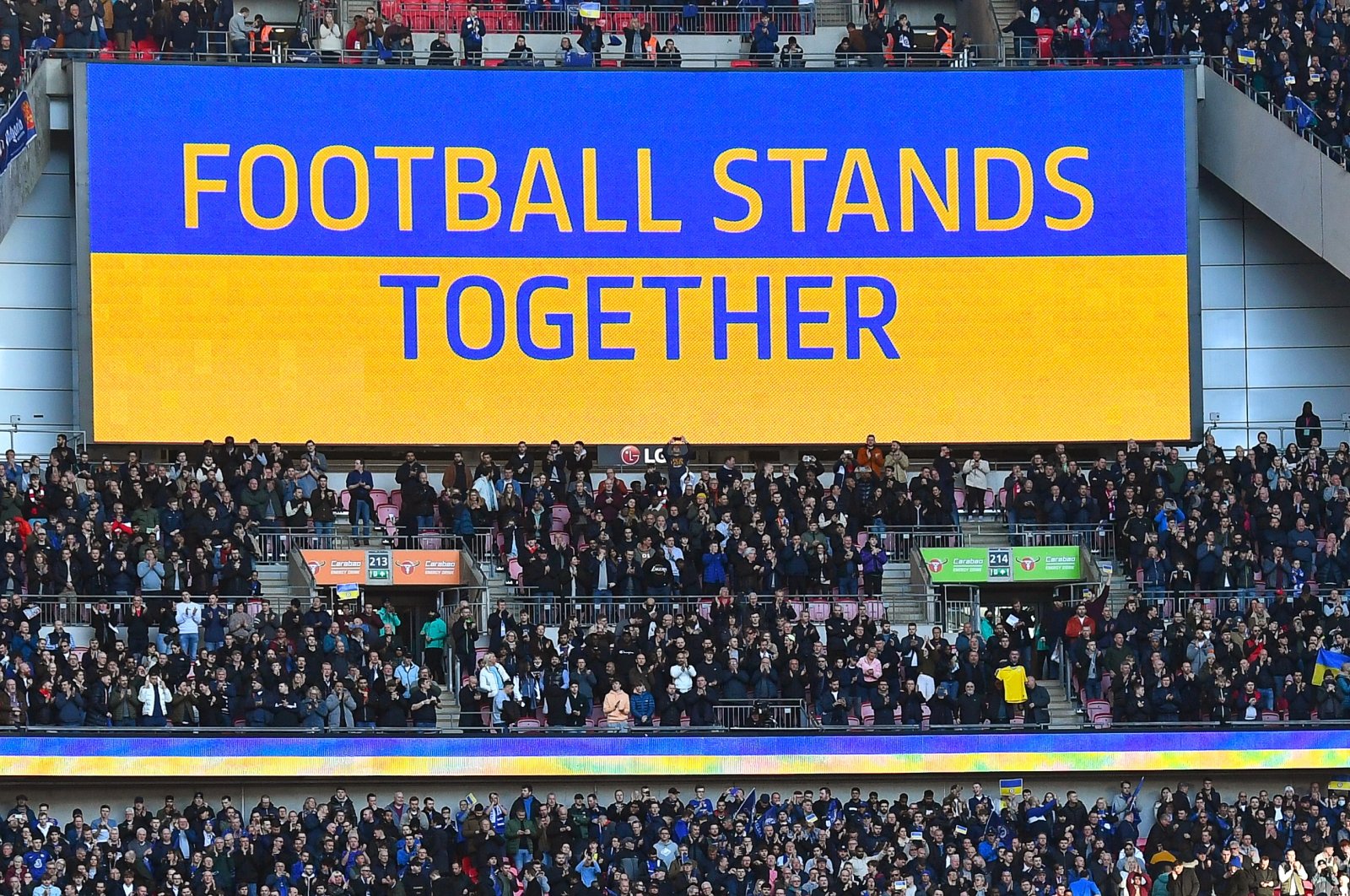 The slogan "Football stands together" is seen on a huge screen before the English Carabao Cup final between Chelsea FC and Liverpool FC at Wembley in London, Britain, Feb. 27, 2022. (EPA Photo)
