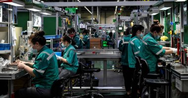 Employees work on a production line at a factory in Beijing, China, Feb. 17, 2022. (AFP Photo)