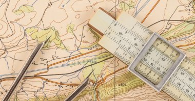 Measuring devices on a topographic map. (Shutterstock Photo)
