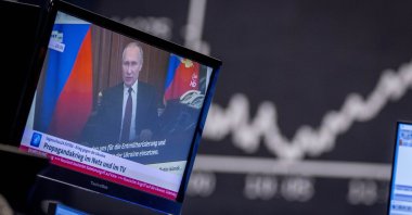 Russia's President Vladimir Putin appears on a television screen at the stock market in Frankfurt, Germany, Feb. 25, 2022. (AP Photo)