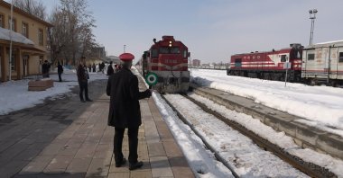The Lake Van Express as it nears its final destination as a conductor greets the train, Tatvan train station, Bitlis, eastern Turkey, March 1, 2022. (IHA Photo)