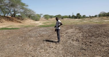 Famine Early Warning System Network in Africa (FEWS NET) scientist Chris Shitote examines a dry water hole in Kilifi county, Kenya, Feb. 16, 2022. (Reuters Photo)