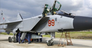 In this photo taken from video provided by the Russian Defense Ministry Press Service on Tuesday, Feb. 15, 2022, an MiG-31 fighter of the Russian air force carrying a Kinzhal hypersonic cruise missile is parked at the Hemeimeem air base in Syria. (Russian Defense Ministry Press Service via AP)