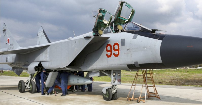 In this photo taken from video provided by the Russian Defense Ministry Press Service on Tuesday, Feb. 15, 2022, an MiG-31 fighter of the Russian air force carrying a Kinzhal hypersonic cruise missile is parked at the Hemeimeem air base in Syria. (Russian Defense Ministry Press Service via AP)