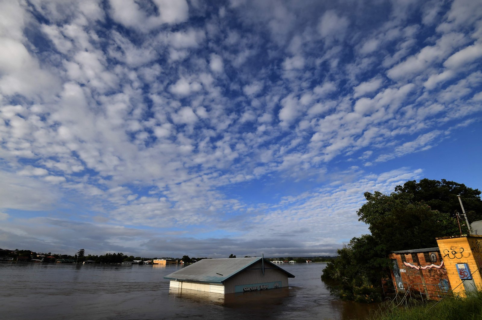 A submerged shed is seen on the bank of the overflowing Clarence River in Grafton, some 130 kilometers (80 miles) from the town of Lismore, New South Wales, Australia, March 1, 2022. (AFP Photo)