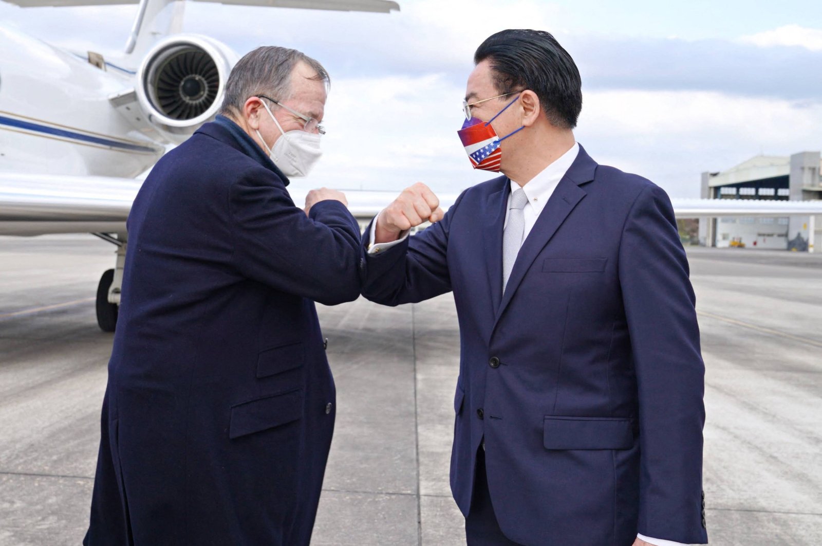 This handout picture taken and released by Taiwan’s Ministry of Foreign Affairs (MOFA) on March 1, 2022, shows Michael Mullen (L), former U.S. chairperson of the Joint Chiefs of Staff, being greeted by Taiwan’s Foreign Minister Joseph Wu (R) upon his arrival at Sungshan Airport in Taipei, Taiwan. (AFP Photo)