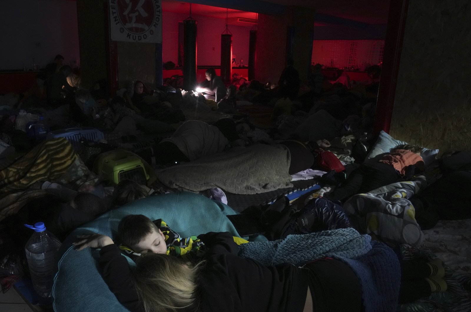 People sleep in the improvised bomb shelter in a sports center, which can accommodate up to 2,000 people, in Mariupol, Ukraine, Feb. 27, 2022. (AP Photo)