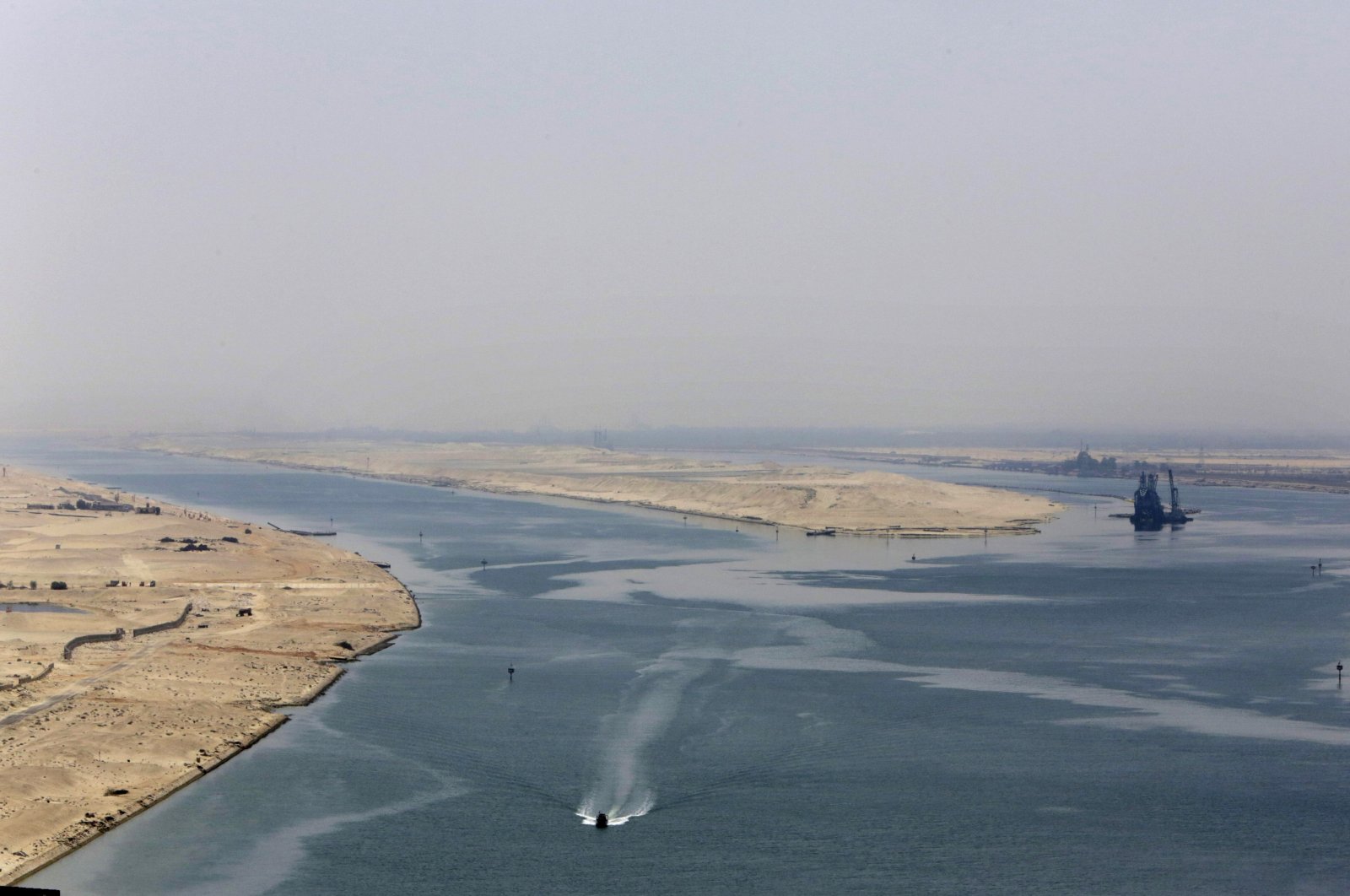 An army zodiac secures the entrance of a new section of the Suez Canal in Ismailia, Egypt, Aug. 6, 2015. (AP Photo)