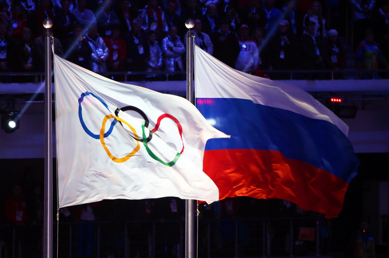 The Olympic flag (L) and the Russian flag on display at the Sochi 2014 Olympic Games closing ceremony, Sochi, Russia, Feb. 23, 2014 (EPA Photo)