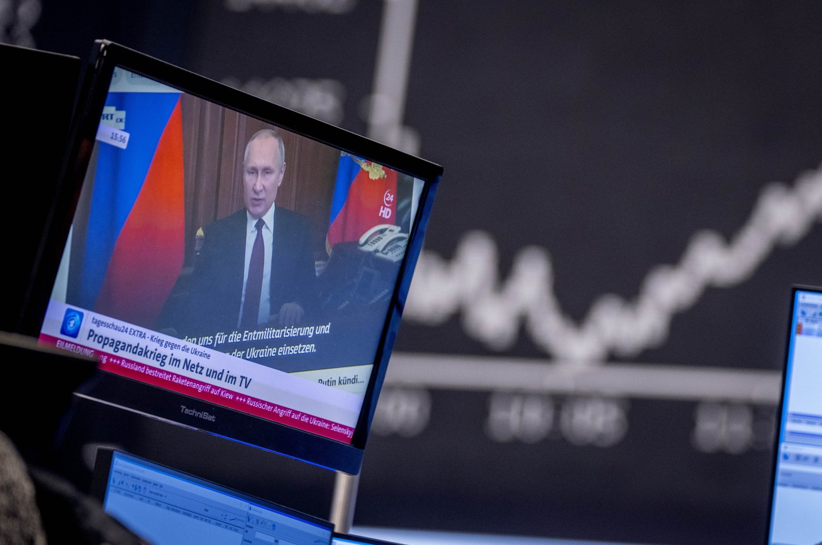 Russia&#039;s President Vladimir Putin appears on a television screen at the stock market in Frankfurt, Germany, Feb. 25, 2022. (AP Photo)