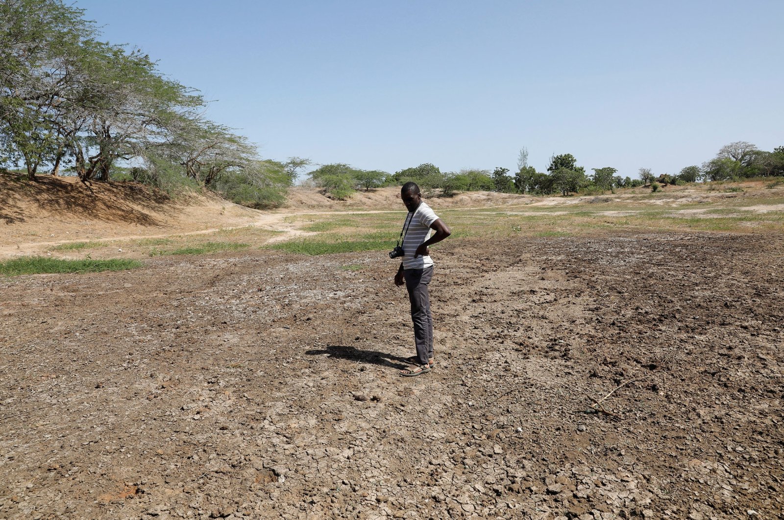 Famine Early Warning System Network in Africa (FEWS NET) scientist Chris Shitote examines a dry water hole in Kilifi county, Kenya, Feb. 16, 2022. (Reuters Photo)