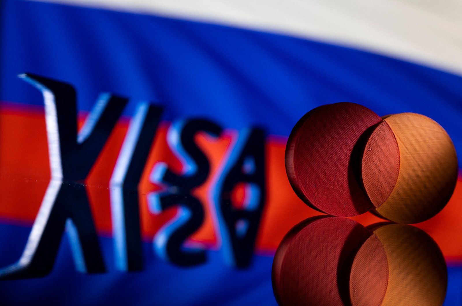 Visa and Mastercard logos are seen in front of Russian flag in this illustration taken March 1, 2022. (Reuters Photo)