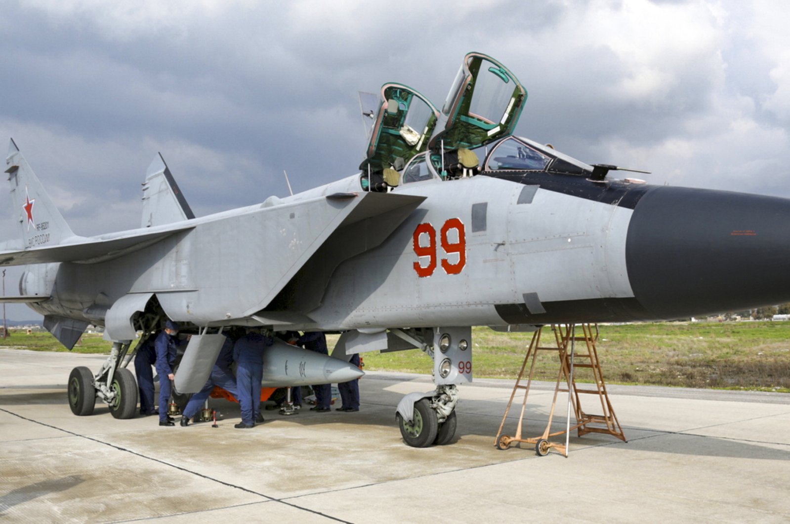 In this photo taken from video provided by the Russian Defense Ministry Press Service on Tuesday, Feb. 15, 2022, an MiG-31 fighter of the Russian air force carrying a Kinzhal hypersonic cruise missile is parked at the Hemeimeem air base in Syria. (Russian Defense Ministry Press Service via AP)