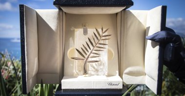 A person holds up a box containing the Palme d'Or award, which will be presented at the 71st international film festival, Cannes, southern France, Tuesday, May 15, 2018. (AP Photo)
