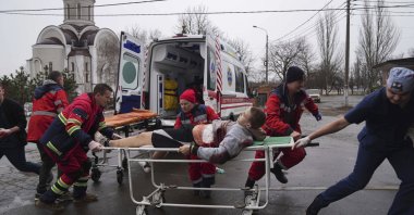 Ambulance paramedics move an injured man on a stretcher, wounded by shelling in a residential area, at a maternity hospital converted into a medical ward and used as a bomb shelter in Mariupol, Ukraine, March 1, 2022. (AP Photo)