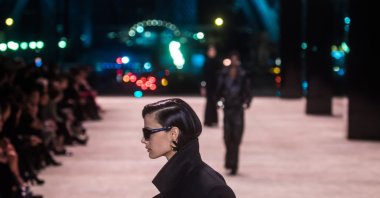 Models on the catwalk with a creation from the Fall/Winter 2022/23 Women collection by Saint Laurent fashion house at Paris Fashion Week, Paris, France, March 1, 2022. (EPA Photo)