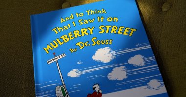 A copy of the book "And to Think That I Saw It on Mulberry Street," by Dr. Seuss, rests in a chair, Walpole, Mass., U.S., March 1, 2021. (AP)