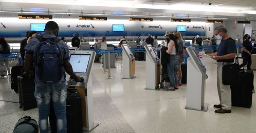 Travelers use the self-service kiosk to check in and pay for luggage at the American Airlines terminal, in Miami, U.S., April 29, 2021. (AP Photo)