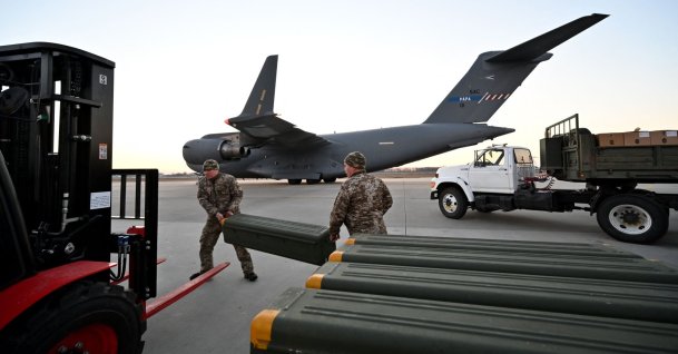 Servicemen of Ukrainian Military Forces move U.S.-made FIM-92 Stinger missiles, a man-portable air-defense system (MANPADS), that operates as an infrared homing surface-to-air missile (SAM), and the other military assistance shipped from Lithuania to Boryspil Airport in Kyiv, Ukraine, Feb. 13, 2022. (AFP Photo)