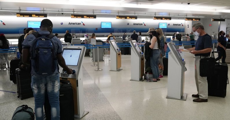 Travelers use the self-service kiosk to check in and pay for luggage at the American Airlines terminal, in Miami, U.S., April 29, 2021. (AP Photo)