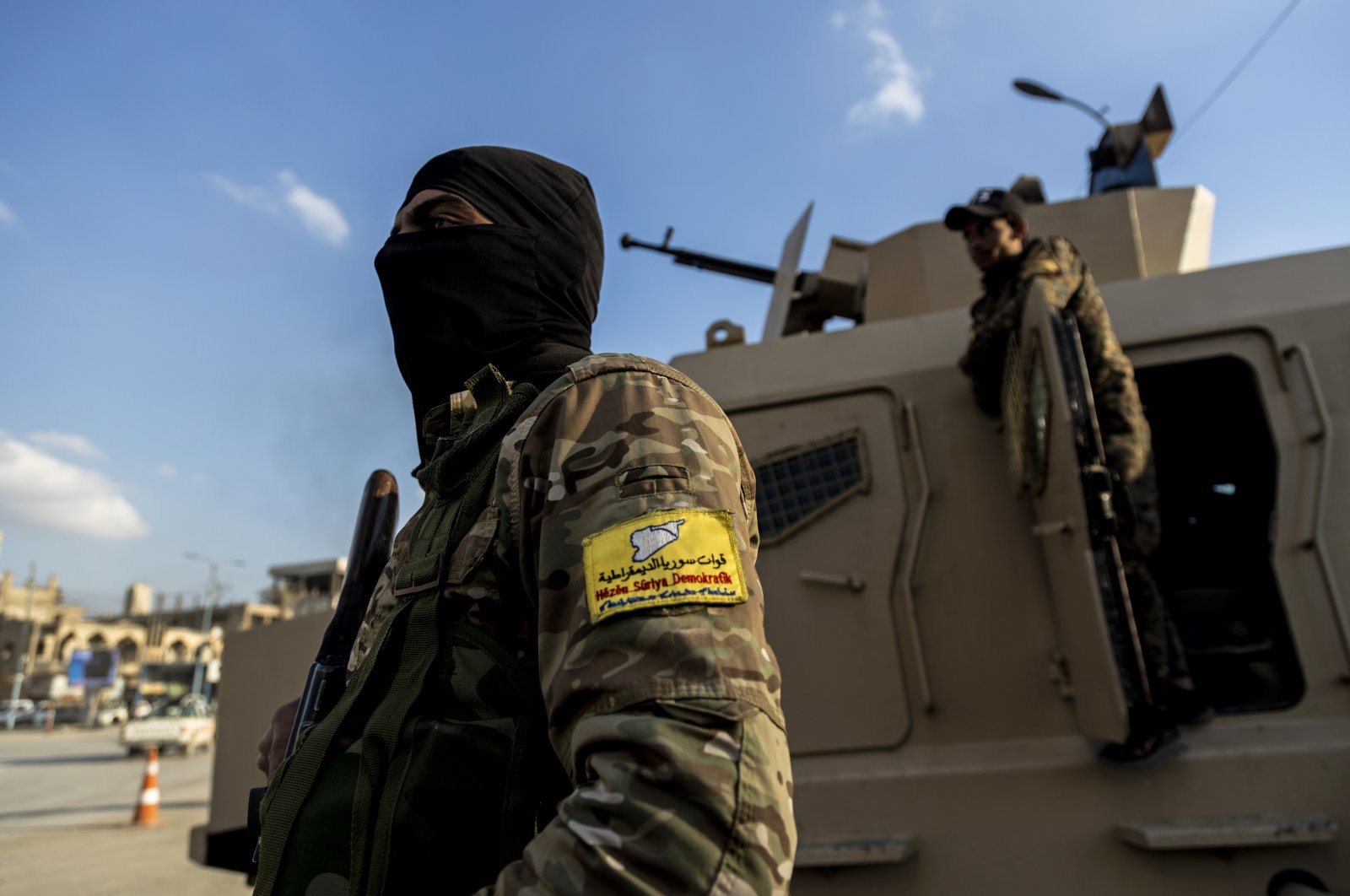 U.S.-backed YPG terrorists stand guard at Al Naeem Square, in Raqqa, Syria, Monday, Feb. 7, 2022. (AP File Photo)