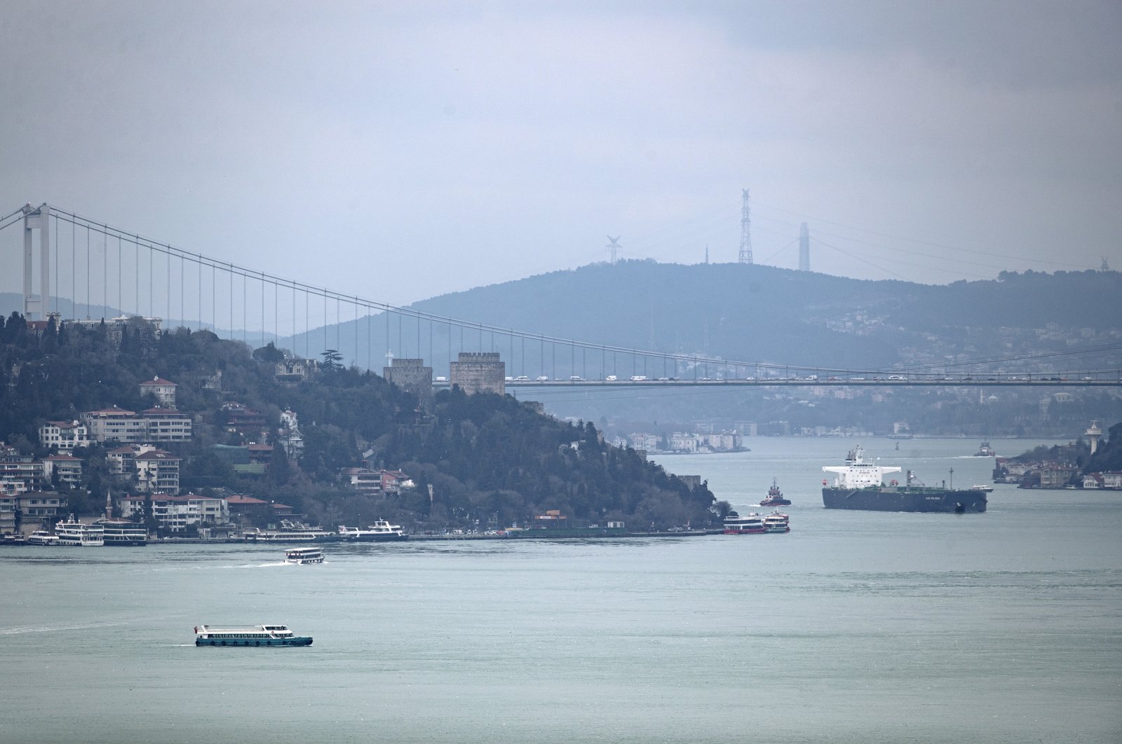 A cargo ship sails under the Fatih Sultan Mehmet Bridge on the Bosporus in Istanbul, Turkey, March 1, 2022. (EPA Photo)