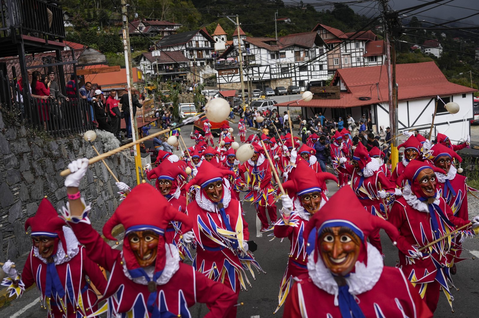 People in Jokimi costumes attend a parade during a carnival celebration in Colonia Tovar, Venezuela, Feb. 26, 2022. (AP Photo)